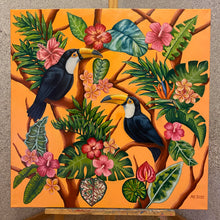 Load image into Gallery viewer, A vivid oil painting capturing toucan birds in a colourful embrace amidst lush tropical foliage. Realism meets contemporary flair against a vibrant orange backdrop. Embrace the exuberant beauty of nature in this captivating artwork.
