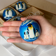 Load image into Gallery viewer, Penguin family painting, blue color, wooden handmade bauble, size of round sphere, by artist Anastasia Kurganova
